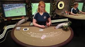 Live baccarat table with dealer and cards